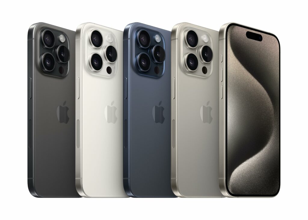 5 iPhone 15 Pros, showing the available colors: Natural Titanium, Blue, White, and Black Titanium