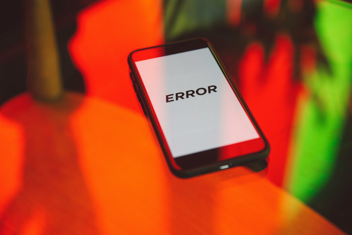 a smartphone with a mostly blank screen with the word ERROR in big bold letters